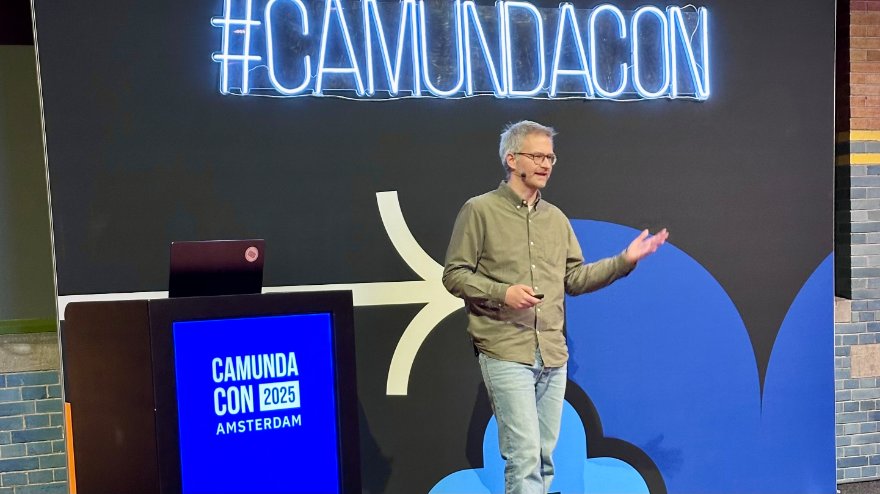 On stage under the #CamundaCon sign at CamundaCon 2025 Amsterdam